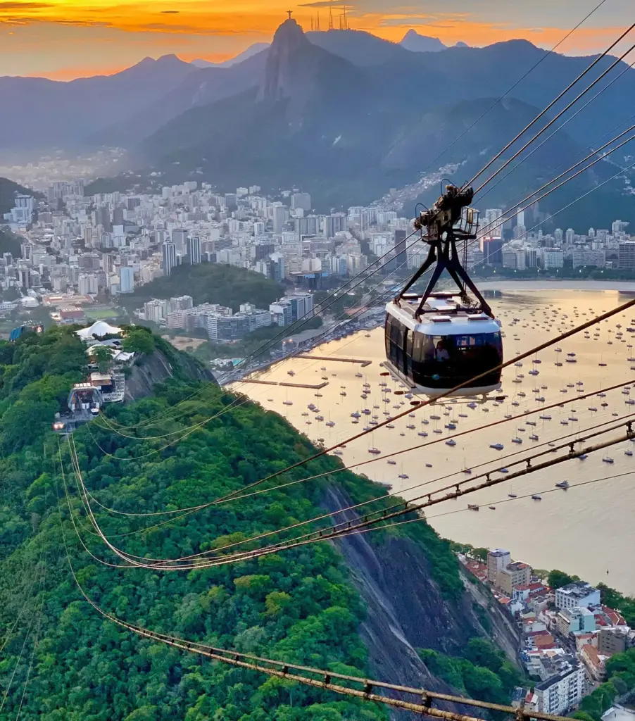 The Sugarloaf cable car at sunset, with Corcovado behind