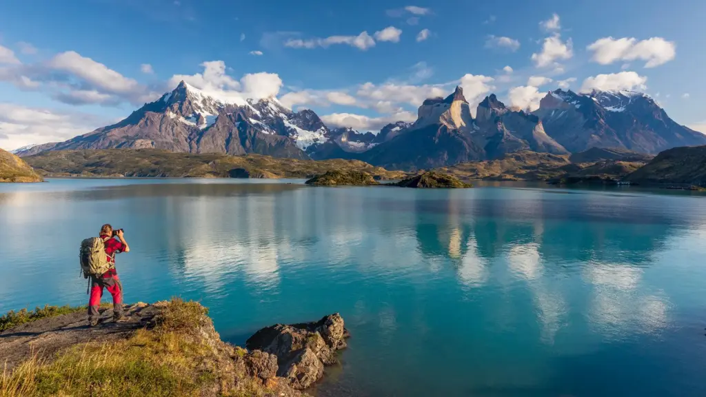 A hiker above Lake Pehoé, with the Cuernos del Paine behind